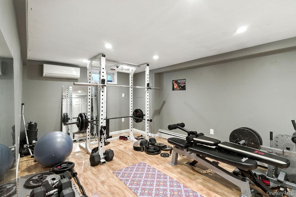 21 Macarthur Avenue Plainview, NY 11803 - Photo 22 of 26 a room with gym equipment and a view of living room
