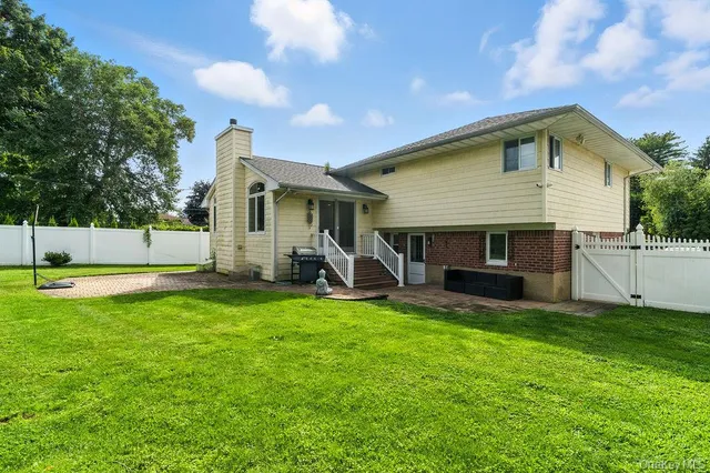 a view of a house with a yard and sitting area