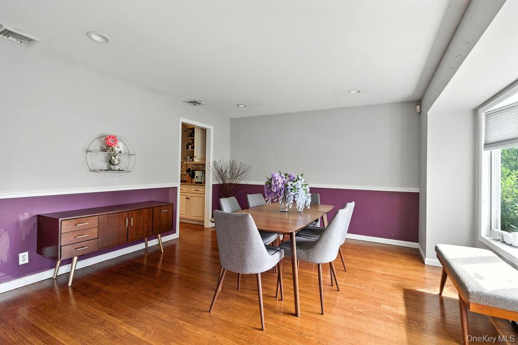 21 Macarthur Avenue Plainview, NY 11803 - Photo 5 of 26 a view of a dining room with furniture and wooden floor