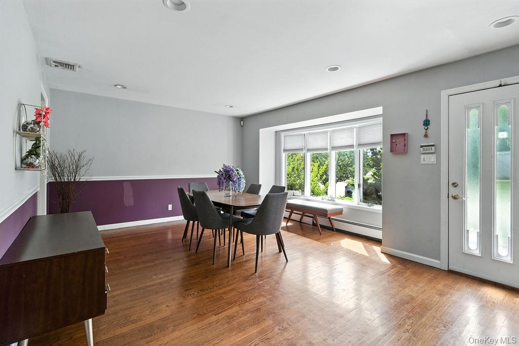 21 Macarthur Avenue Plainview, NY 11803 - Photo 6 of 26 a view of a dining room with furniture and wooden floor