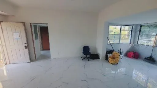 a room with a baby crib furniture and a window