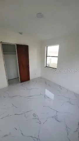 an outdoor space with patio furniture and white kitchen