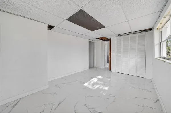 an entryway with a rug and a window