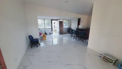 an entryway and livingroom with furniture