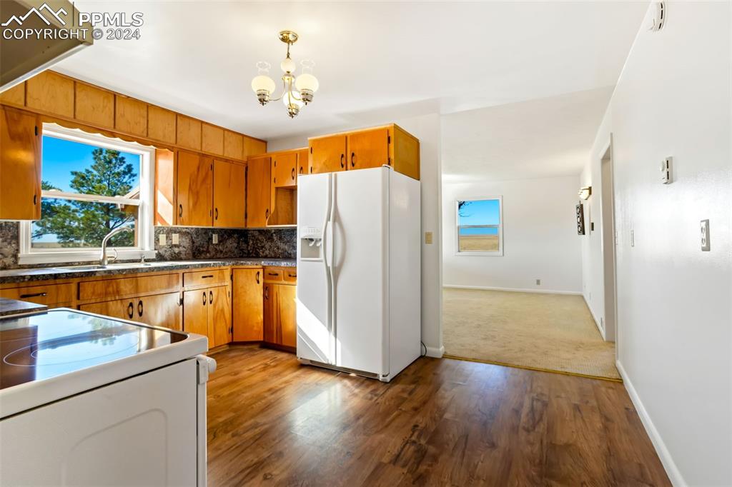 375 North Rush Road Rush, CO 80833 - Photo 8 of 32 a view of a kitchen with a refrigerator wooden floor and a kitchen