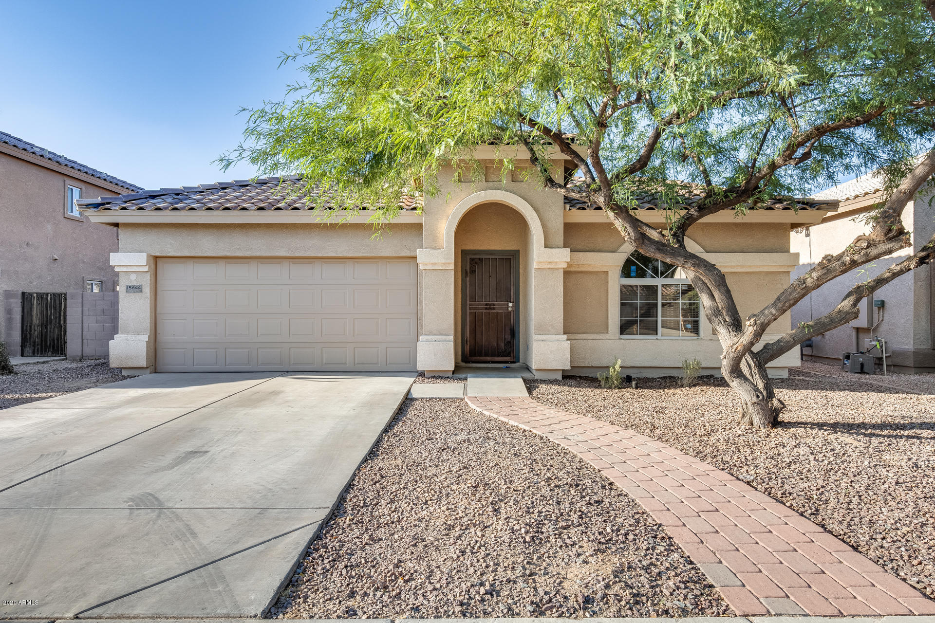 15644 West Calavar Road Surprise, AZ 85379 - Photo 1 of 34 a front view of a house with a yard and garage