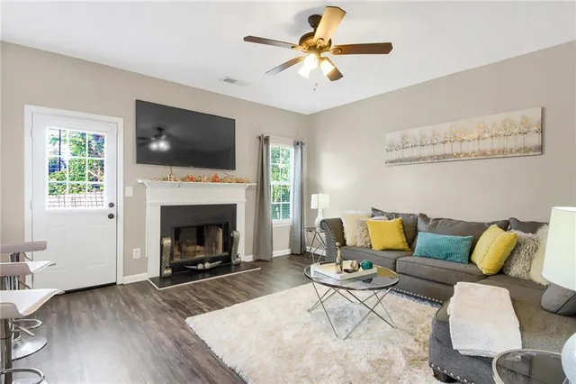 a living room with furniture a flat screen tv and a fireplace
