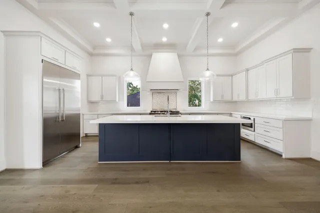 a kitchen with kitchen island a sink stainless steel appliances and cabinets