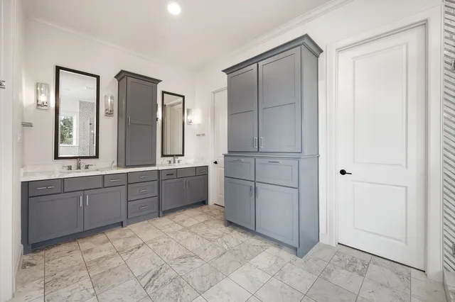 a kitchen with a refrigerator sink and cabinets