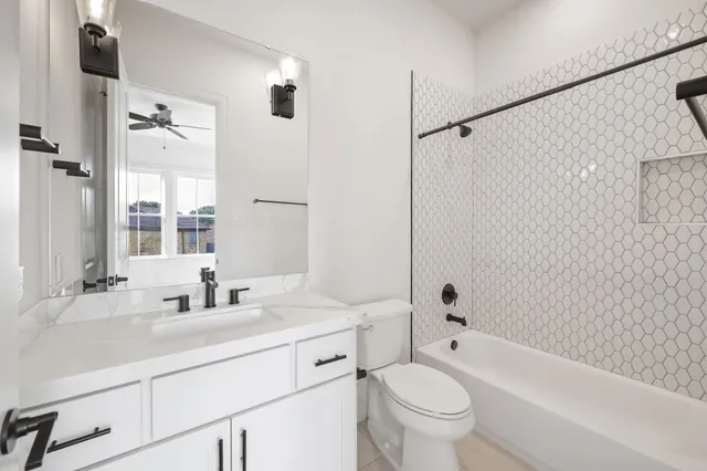 a bathroom with a sink a toilet and a large mirror