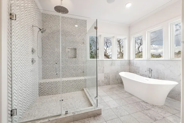 a bathroom with a bathtub and shower