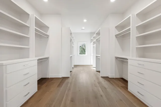 a view of walk in closet with empty racks