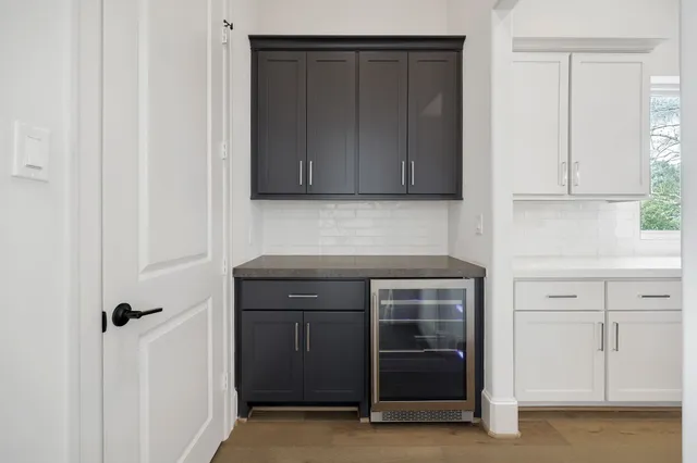 a kitchen with granite countertop white cabinets and a stove