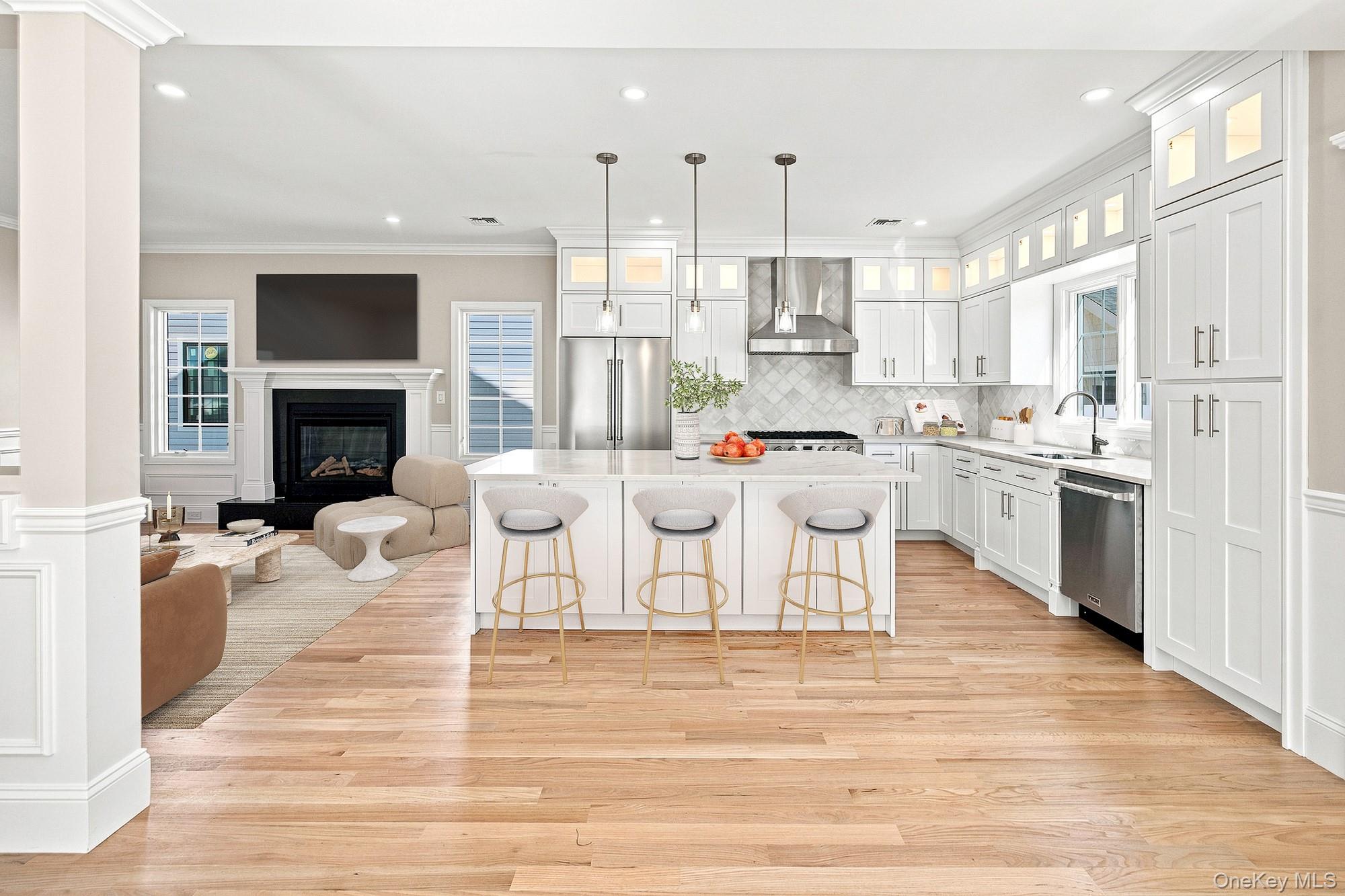 148 Latham Road Mineola, NY 11501 - Photo 7 of 27 Spacious kitchen with white shaker cabinetry, stainless steel appliances, and a central island with pendant lighting.VIRTUAL STAGING