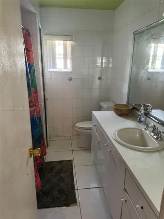 a bathroom with a sink a toilet and mirror