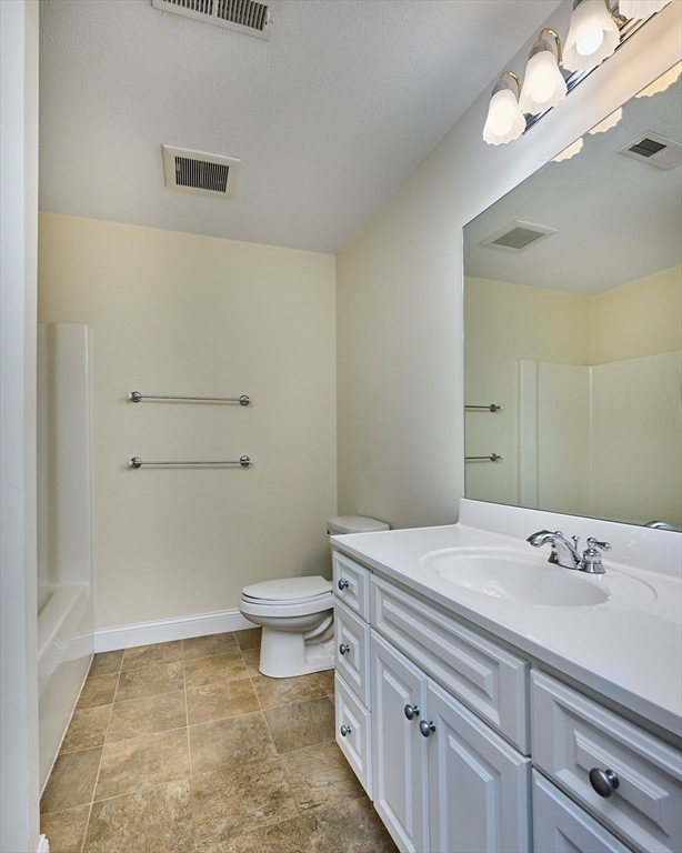 8 Hockanum Road, Unit 10 Northampton, MA 01060 - Photo 15 of 34 a bathroom with a sink a toilet and a mirror