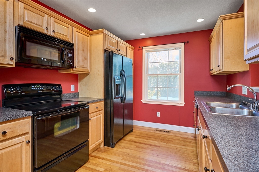 8 Hockanum Road, Unit 10 Northampton, MA 01060 - Photo 3 of 34 a kitchen with stainless steel appliances granite countertop a stove microwave and sink