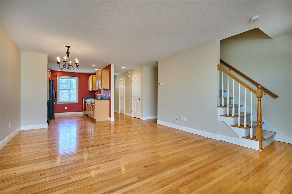 8 Hockanum Road, Unit 10 Northampton, MA 01060 - Photo 5 of 34 a view of an entryway with wooden floor and a chandelier