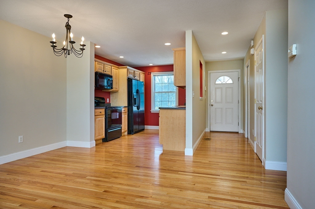 8 Hockanum Road, Unit 10 Northampton, MA 01060 - Photo 6 of 34 a view of a hallway with wooden floor and a kitchen