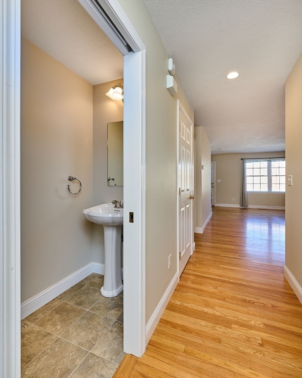 8 Hockanum Road, Unit 10 Northampton, MA 01060 - Photo 8 of 34 a view of a hallway with wooden floor and glass door