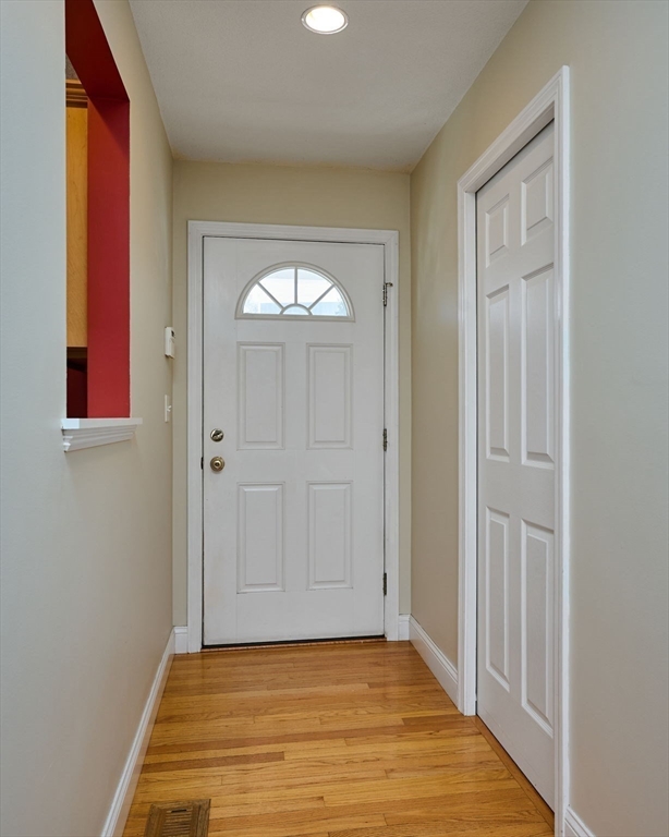 8 Hockanum Road, Unit 10 Northampton, MA 01060 - Photo 10 of 34 a view of an empty room with wooden floor and a window