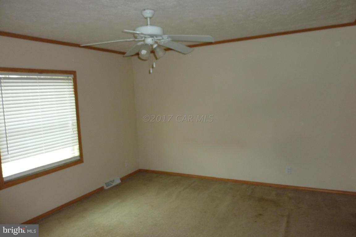6380 Powellville Road Willards, MD 21874 - Photo 6 of 10 an empty room with a window and a fan