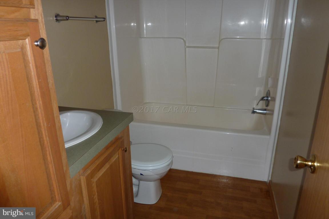 6380 Powellville Road Willards, MD 21874 - Photo 10 of 10 a bathroom with a granite countertop sink toilet and shower