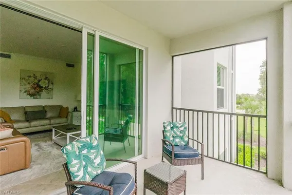 a dining room with furniture window and outside view