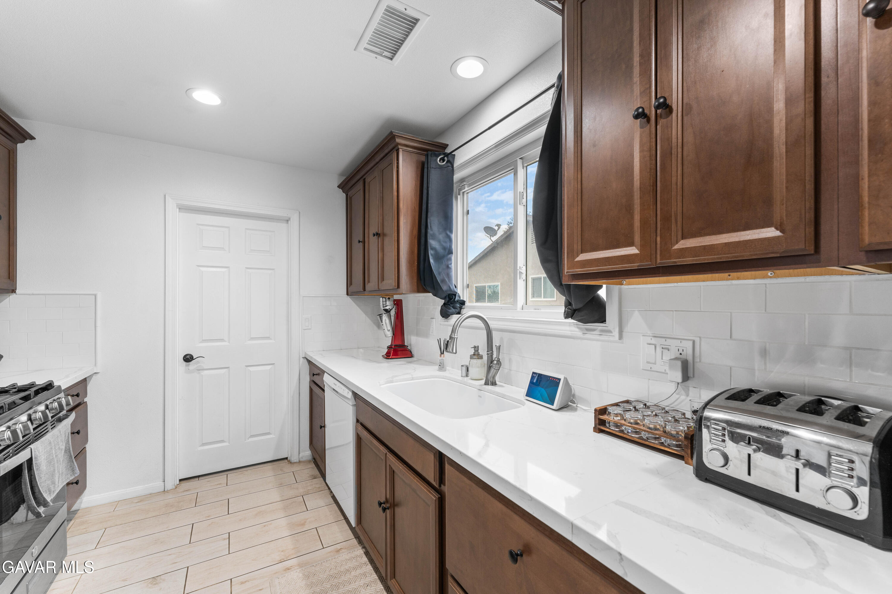 5237 West Ave L8 Lancaster, CA 93536 - Photo 13 of 38 a kitchen with a sink and a stove top oven