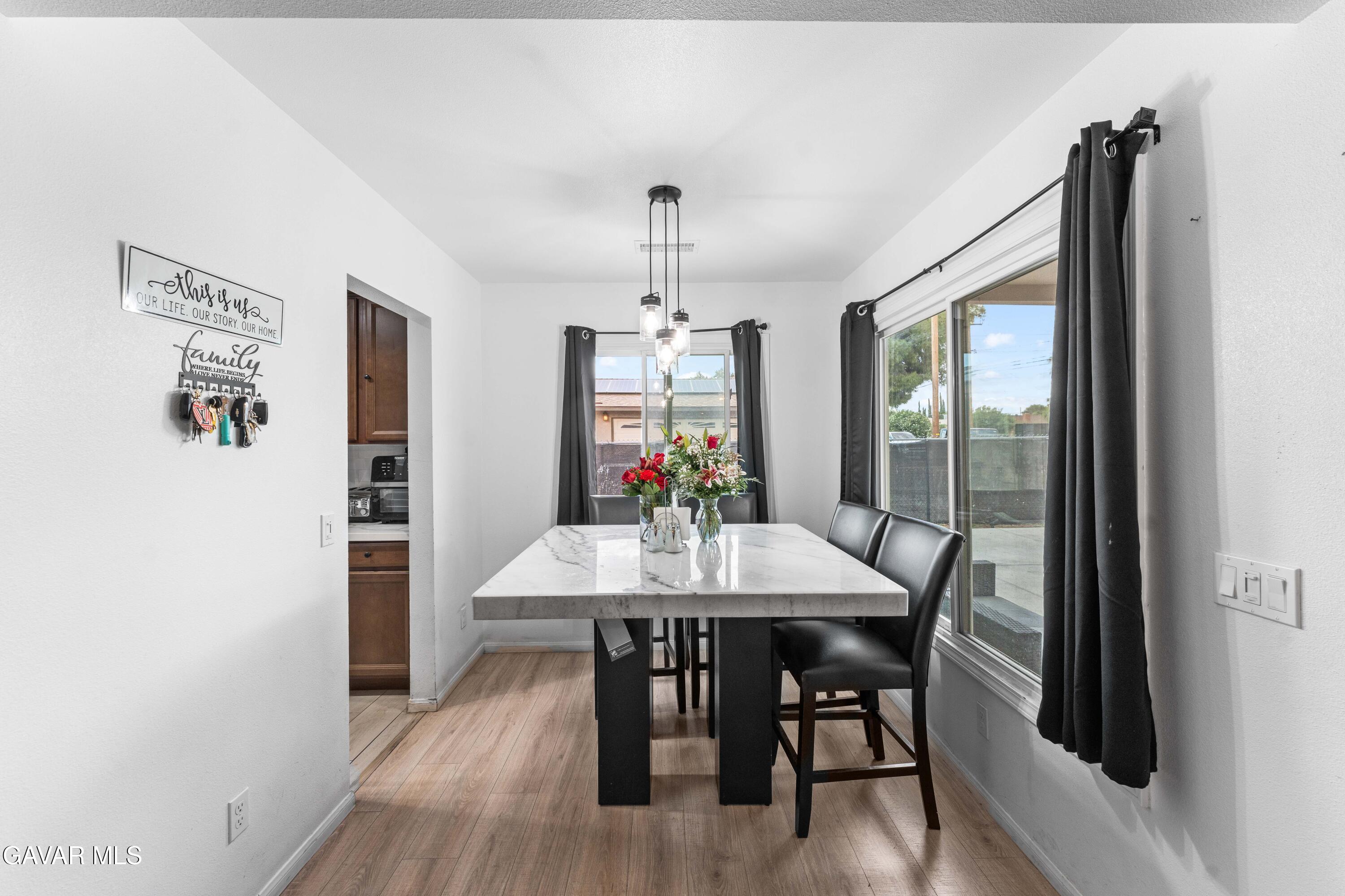 5237 West Ave L8 Lancaster, CA 93536 - Photo 14 of 38 a view of a dining room with furniture window and wooden floor