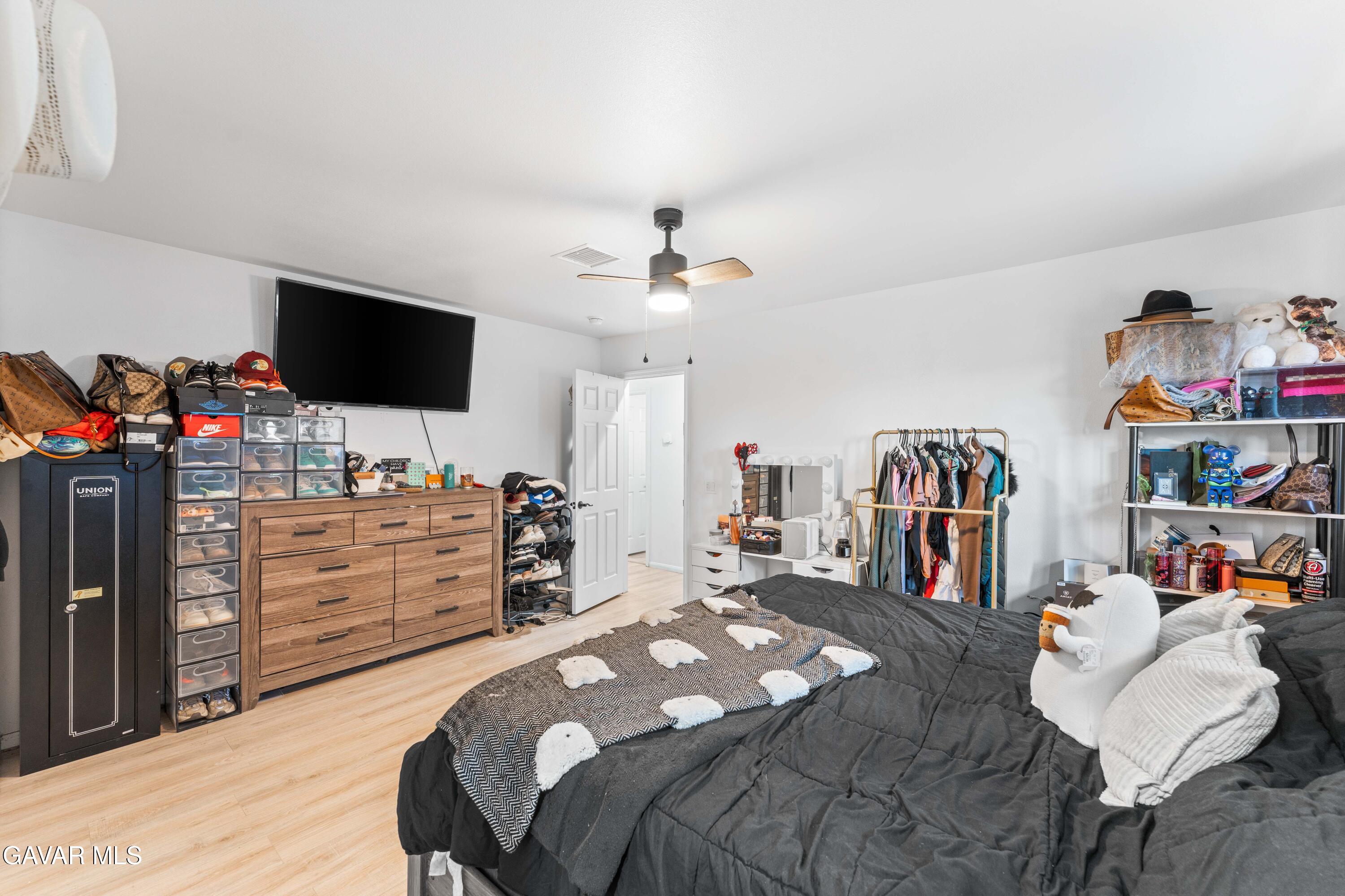 5237 West Ave L8 Lancaster, CA 93536 - Photo 18 of 38 a bedroom with a bed and a flat screen tv