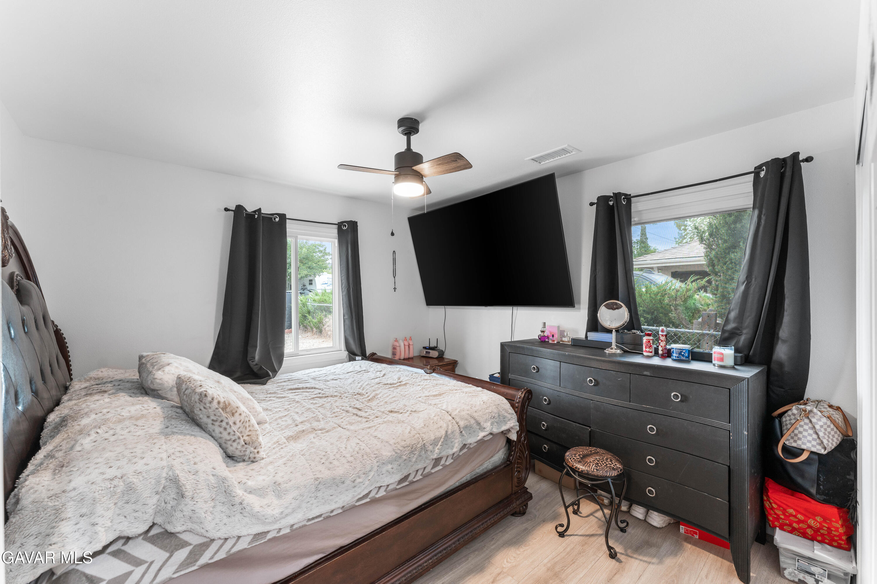5237 West Ave L8 Lancaster, CA 93536 - Photo 20 of 38 a bedroom with a bed and a flat screen tv