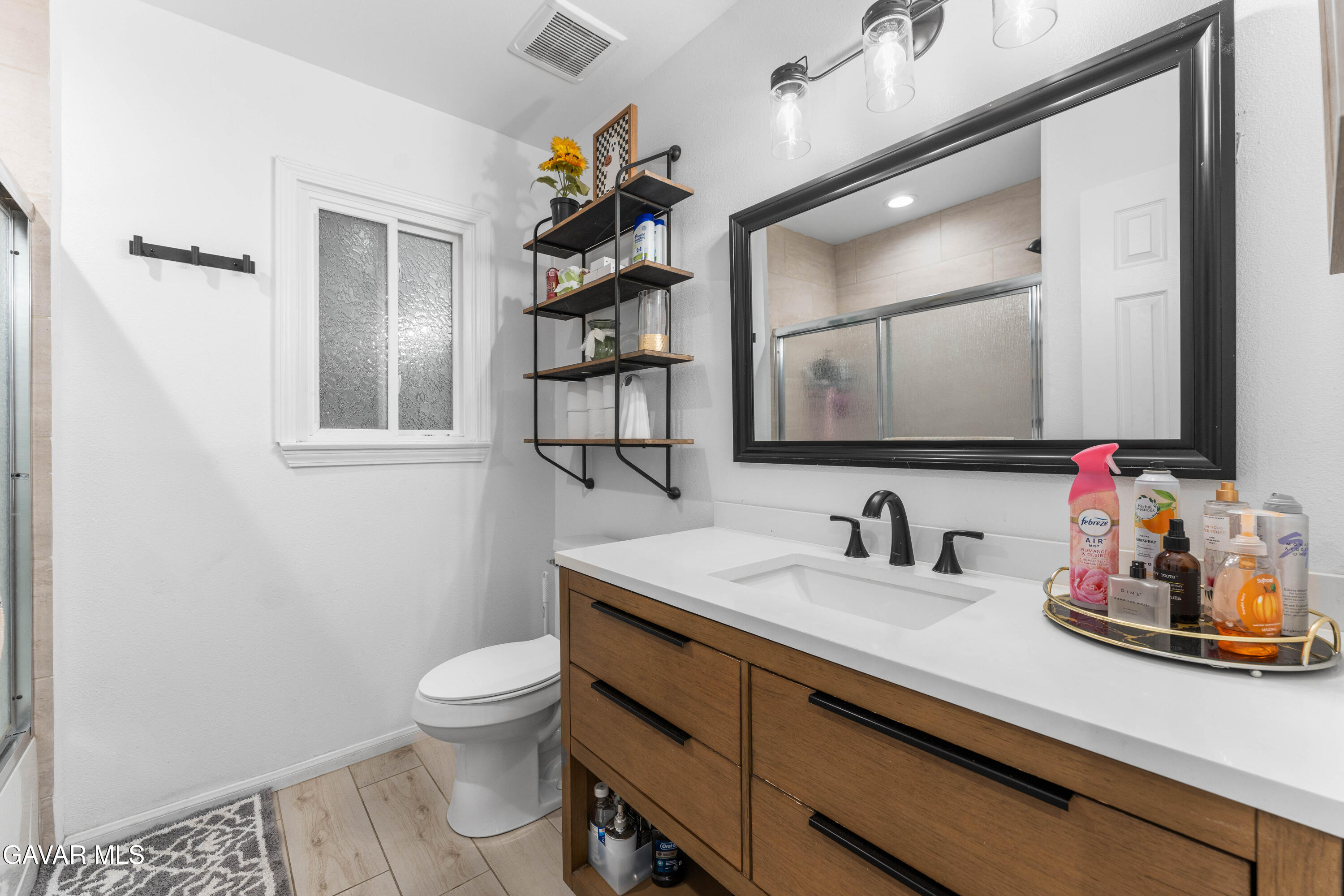 5237 West Ave L8 Lancaster, CA 93536 - Photo 23 of 38 a bathroom with a toilet sink and mirror