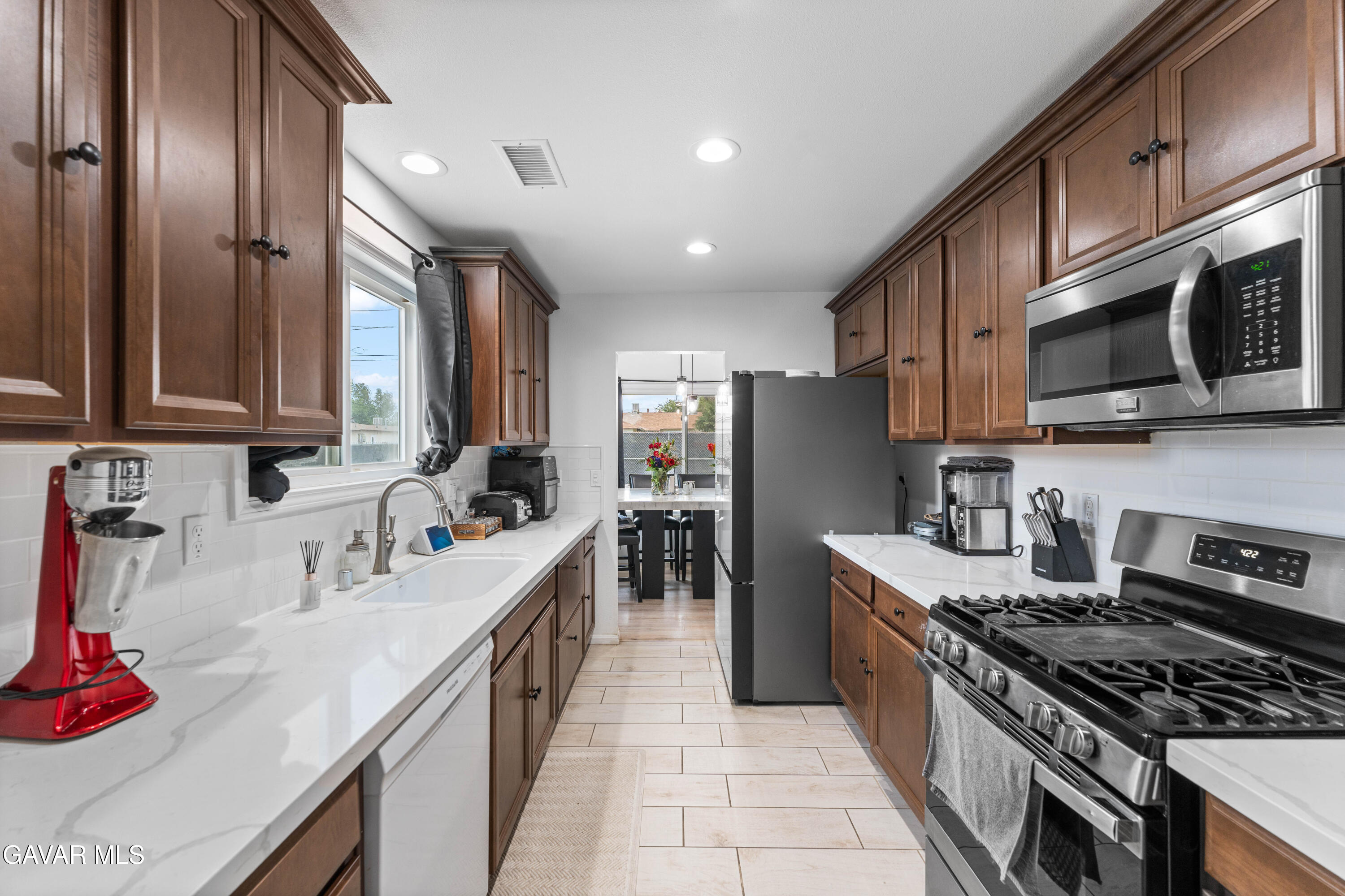 5237 West Ave L8 Lancaster, CA 93536 - Photo 8 of 38 a kitchen with stainless steel appliances granite countertop a sink stove refrigerator and cabinets