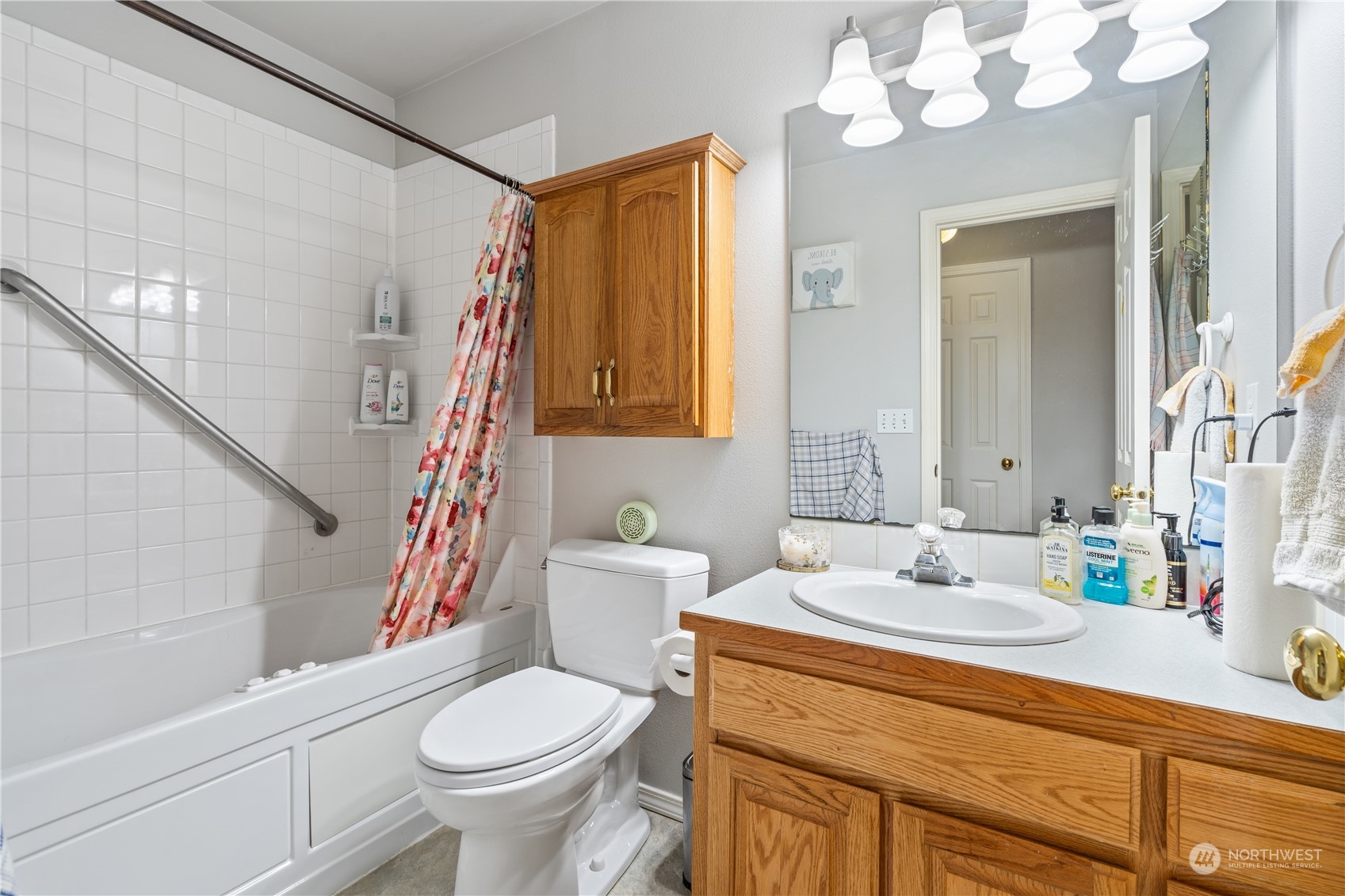19318 2nd Drive Southeast, Unit B Bothell, WA 98012 - Photo 15 of 28 a bathroom with a sink a toilet a mirror and shower