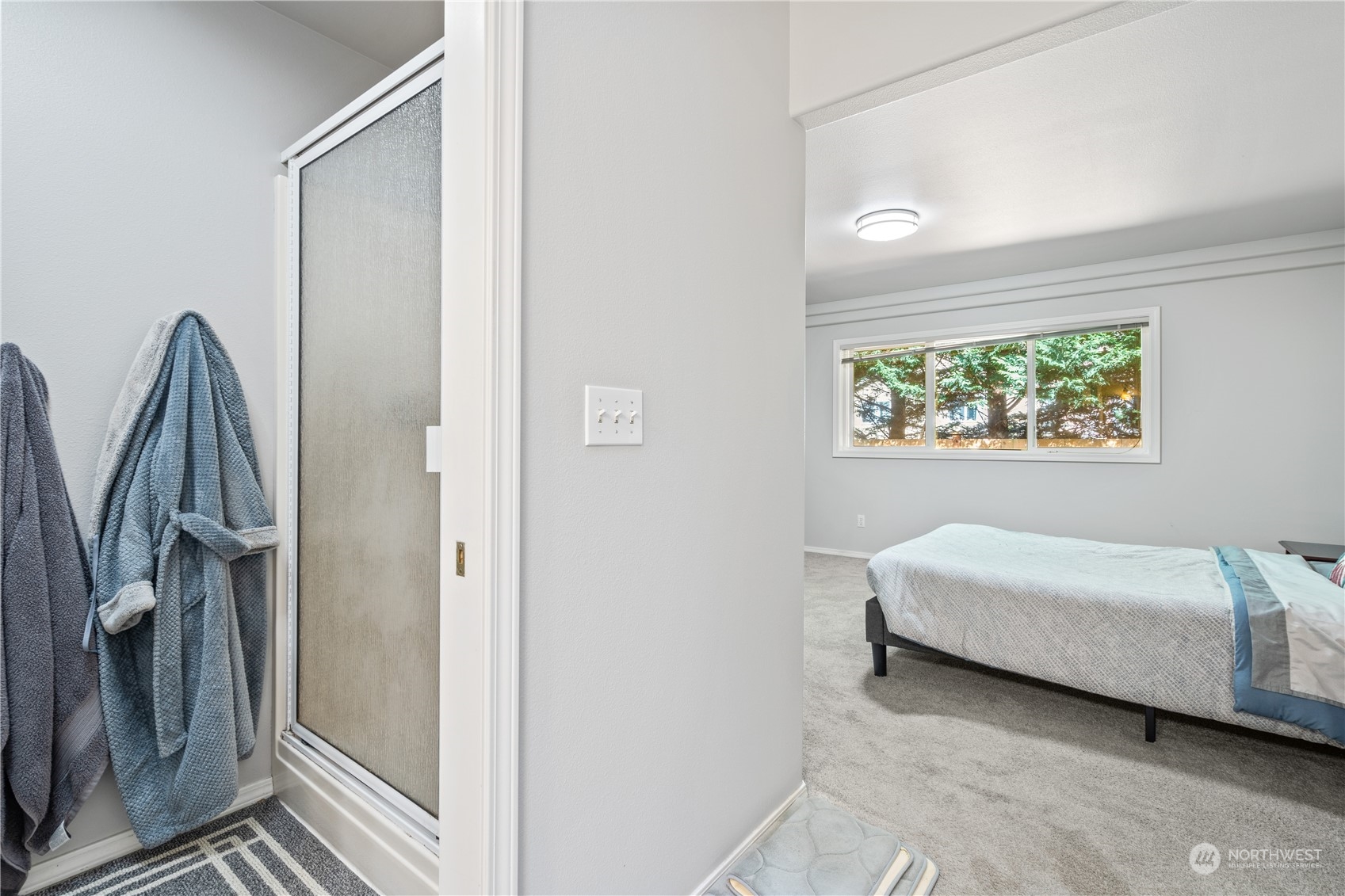 19318 2nd Drive Southeast, Unit B Bothell, WA 98012 - Photo 20 of 28 a bedroom with a bed and a window