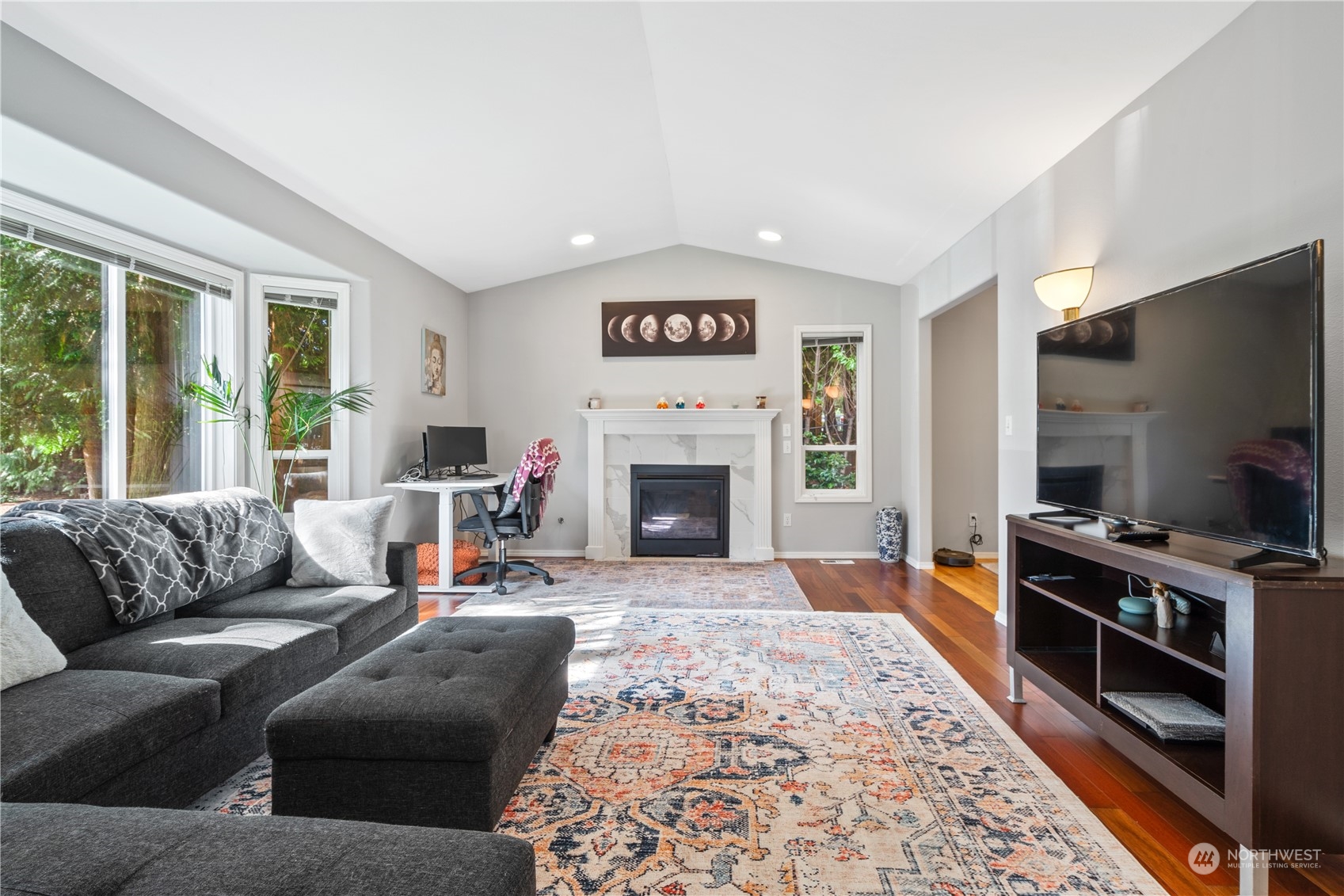 19318 2nd Drive Southeast, Unit B Bothell, WA 98012 - Photo 6 of 28 a living room with furniture a flat screen tv and a fireplace