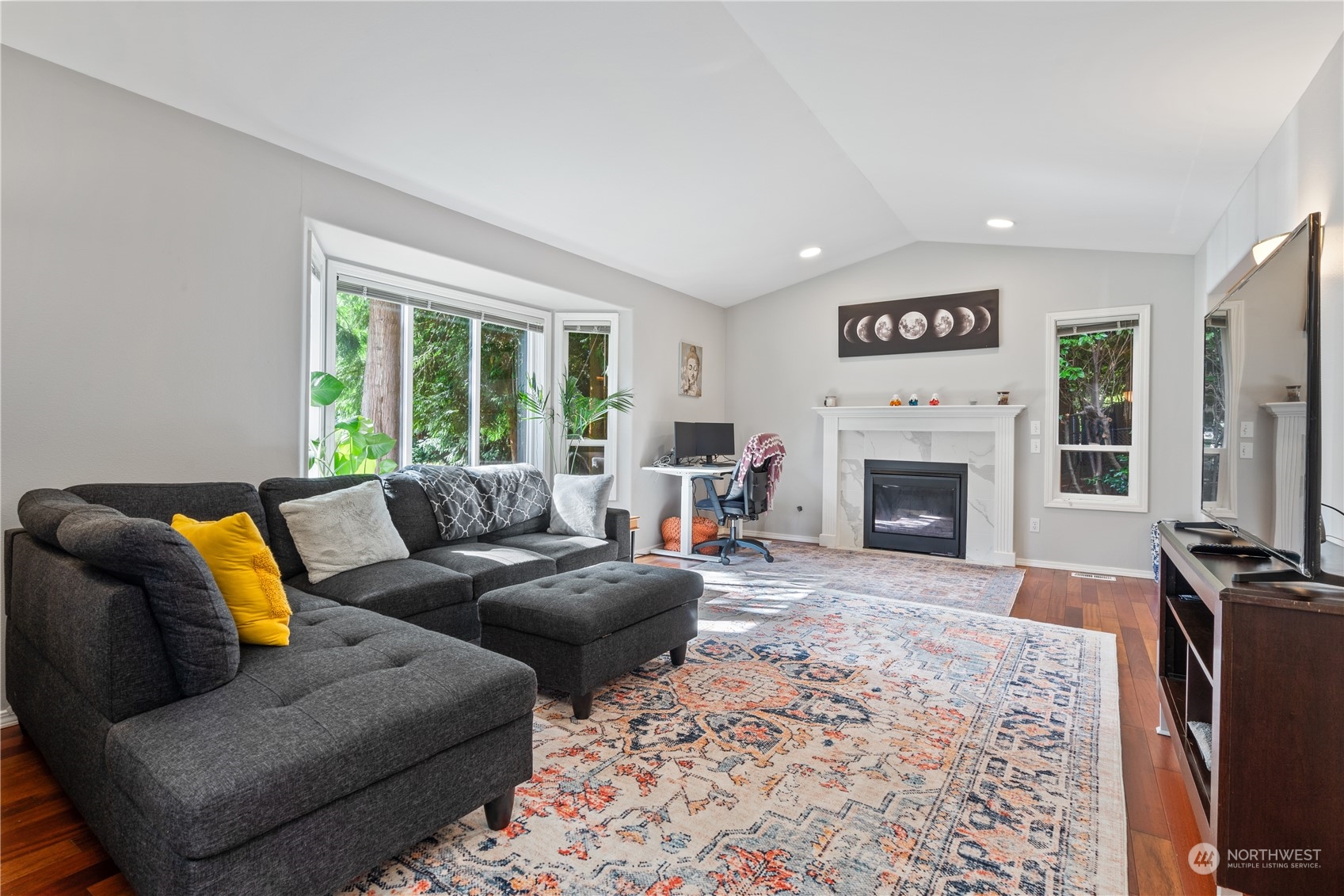 19318 2nd Drive Southeast, Unit B Bothell, WA 98012 - Photo 8 of 28 a living room with furniture flat screen tv and a fireplace
