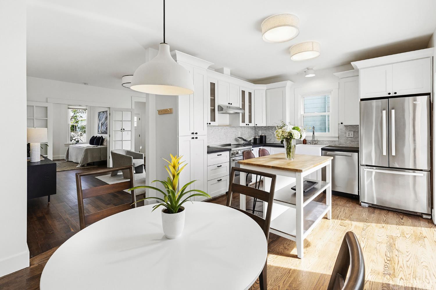 1610 Oregon Street Berkeley, CA 94703 - Photo 18 of 68 a kitchen with stainless steel appliances a dining table a dining table chairs and chandelier