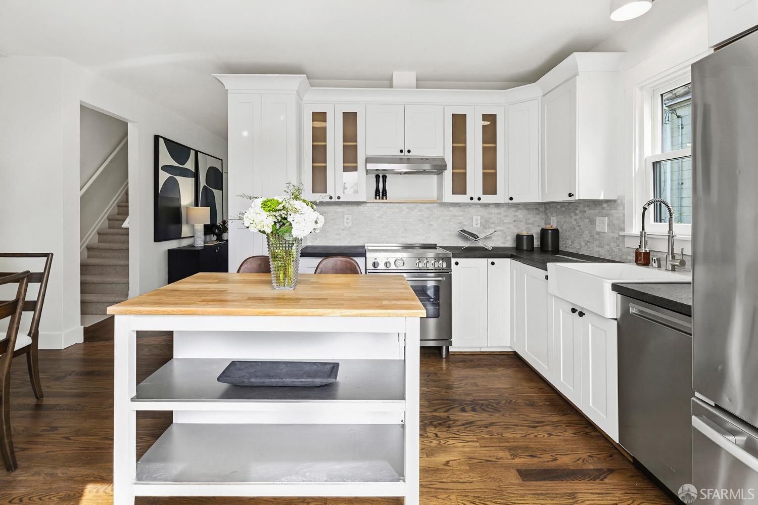 1610 Oregon Street Berkeley, CA 94703 - Photo 22 of 68 a kitchen with stainless steel appliances kitchen island granite countertop a stove a sink dishwasher and a refrigerator with wooden floor