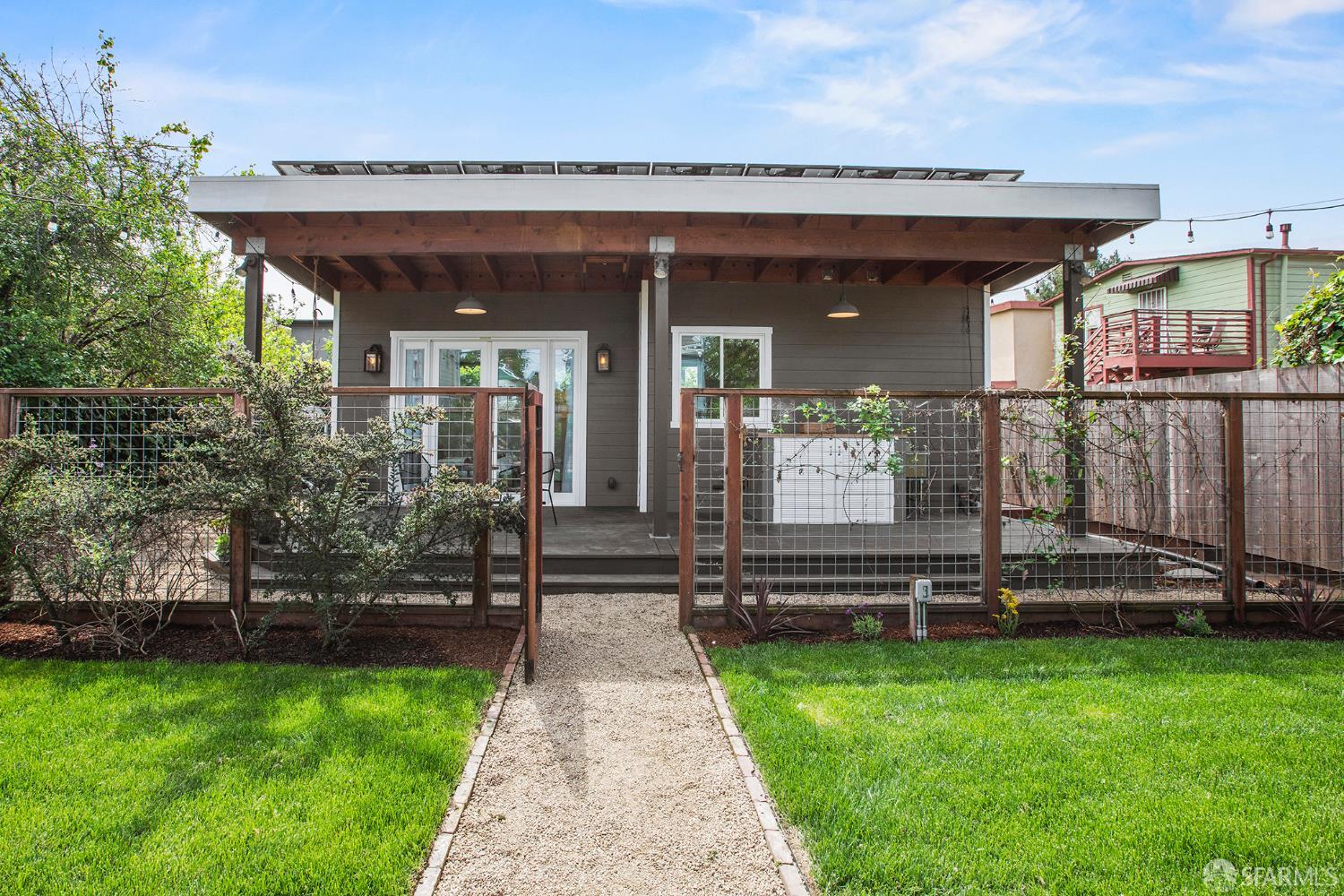 1610 Oregon Street Berkeley, CA 94703 - Photo 37 of 68 a view of a house with a large window and a yard