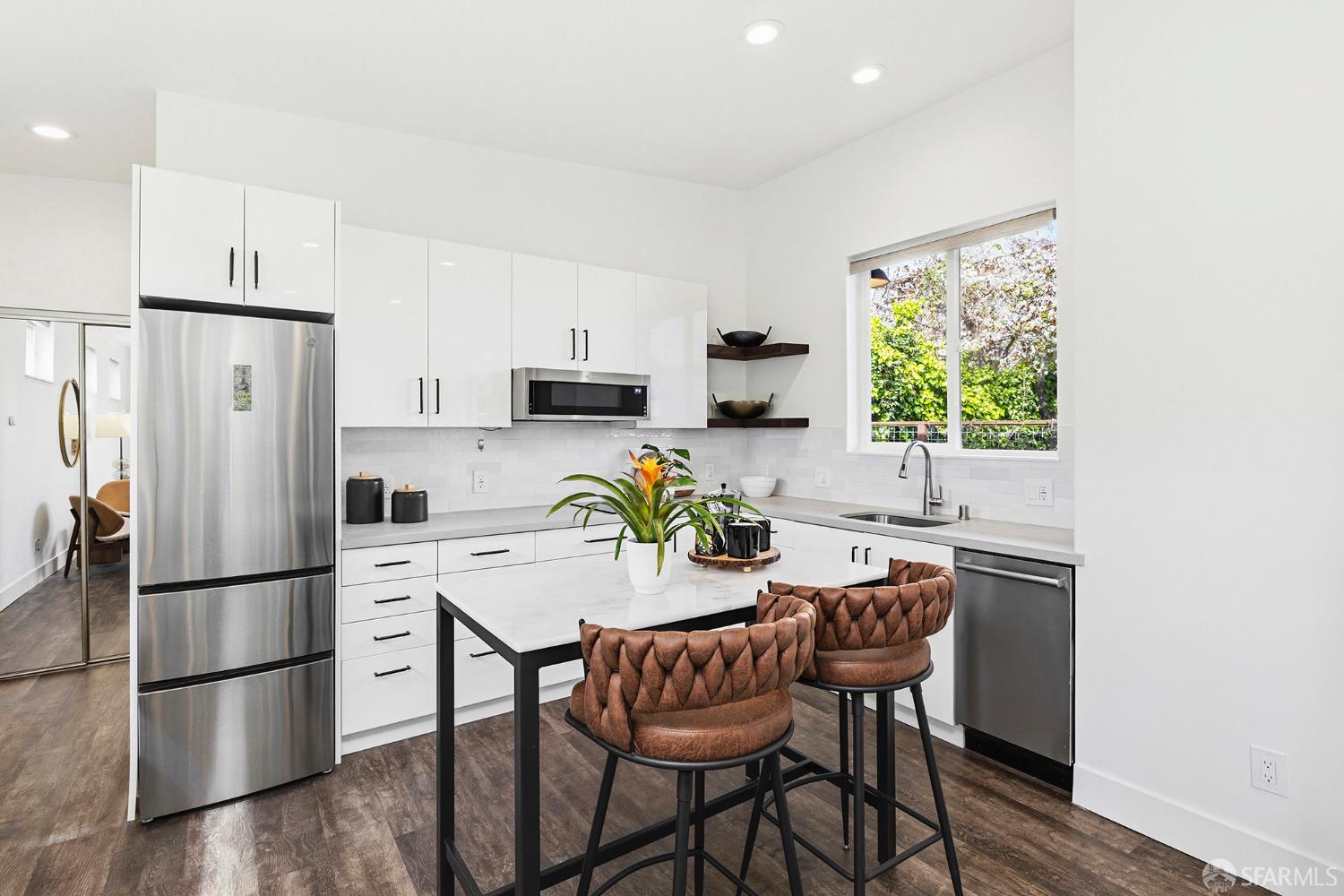 1610 Oregon Street Berkeley, CA 94703 - Photo 43 of 68 a kitchen with a refrigerator a stove a dining table and chairs