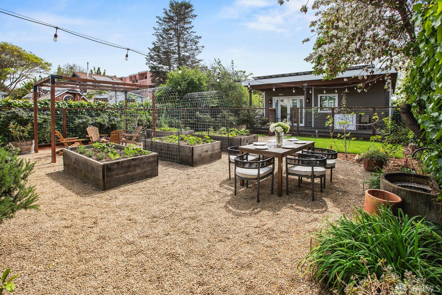 1610 Oregon Street Berkeley, CA 94703 - Photo 52 of 68 a view of a patio with a dining table and chairs with a small yard