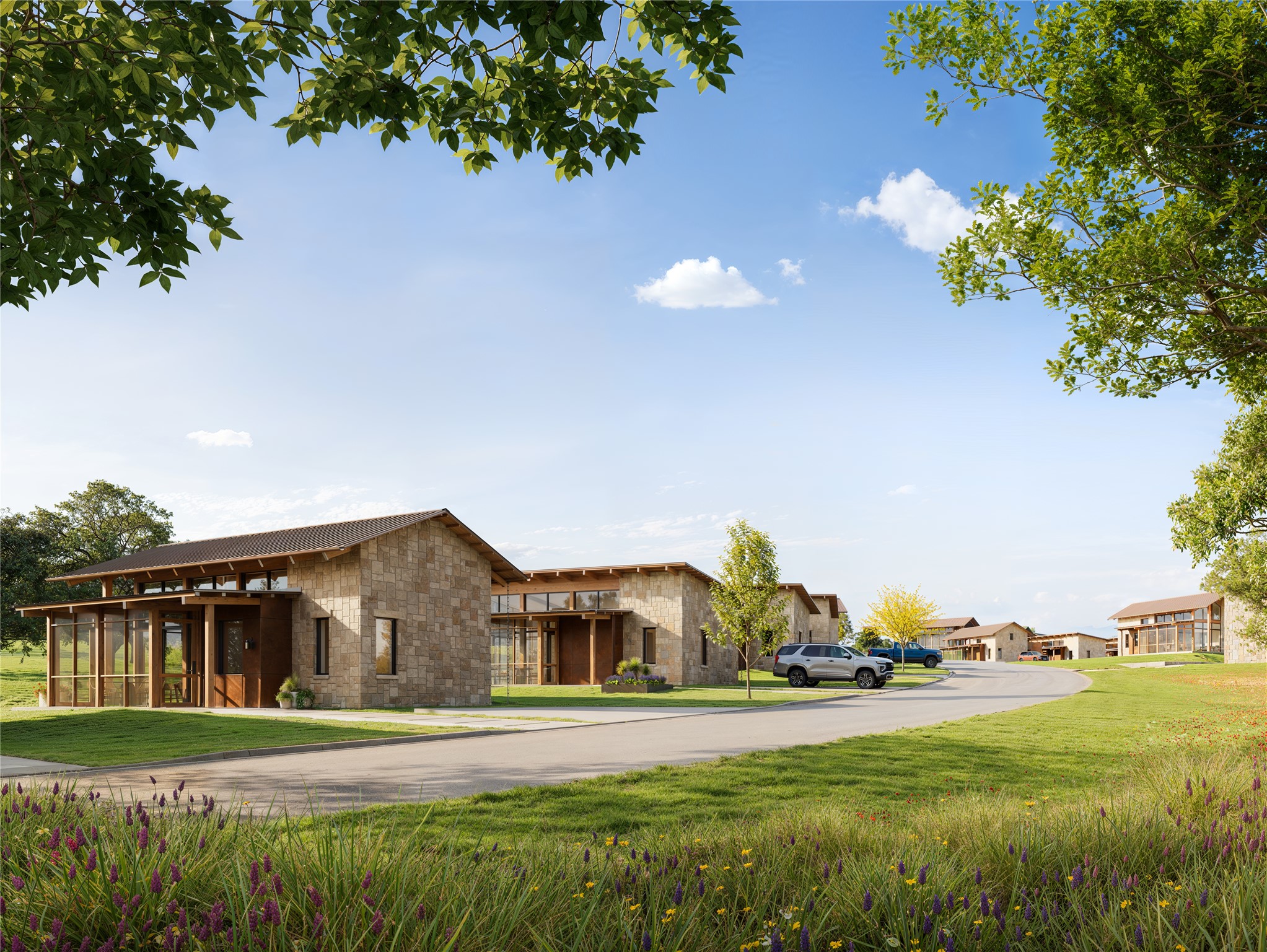 310 Hye Springs Road, Unit 107 Hye, TX 78635 - Photo 17 of 20 Beautiful streetscape featuring modern Hill Country architecture, landscaped green spaces, and a peaceful neighborhood setting designed for relaxed luxury living.