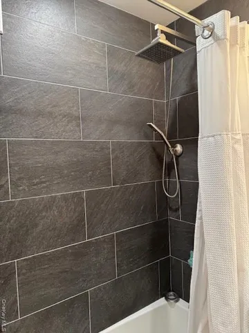 a bathroom with a shower curtain and a sink
