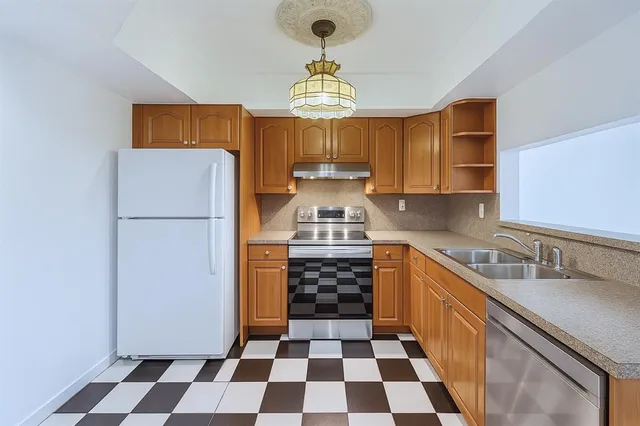 a kitchen with a refrigerator a sink and a stove