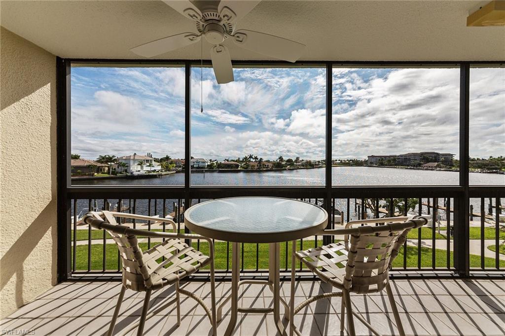 a view of a balcony with chairs and wooden floor