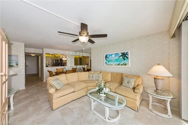 a living room with furniture and a ceiling fan