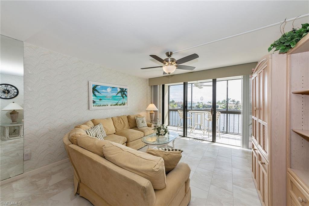 591 Seaview Court, Unit A306 Marco Island, FL 34145 - Photo 4 of 16 a living room with furniture and a large window