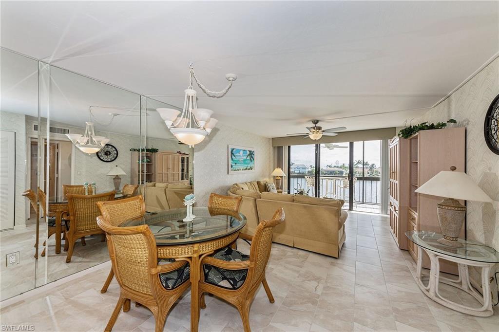 591 Seaview Court, Unit A306 Marco Island, FL 34145 - Photo 5 of 16 a dining room with furniture and window